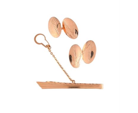 
	
		A PAIR OF 1970S CUFFLINKS AND A SIMILAR TIE CLIP 
		The cufflinks with oval panels with etched decoration, with baton co