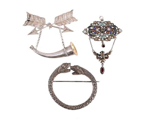 
	
		THREE BROOCHES 
		To include a double headed serpent brooch, with cased heads and scales, unmarked; an Austro Hungarian 