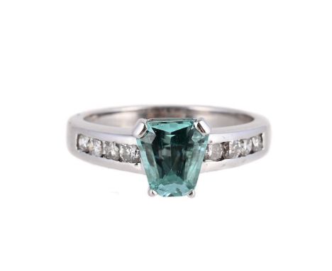 
	
		A BLUE TOURMALINE AND DIAMOND RING 
		The tapered step cut tourmaline within a four claw setting, to 18 carat white gold