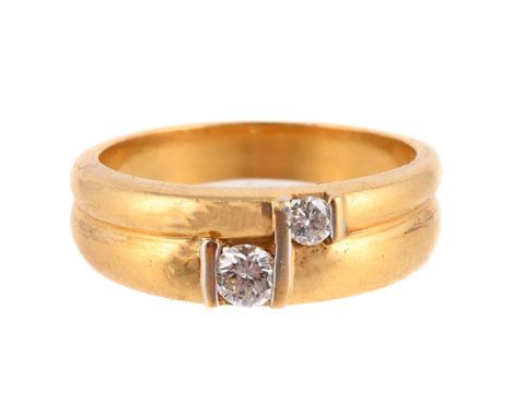 
	
		A TWO STONE DIAMOND RING 
		The reeded band ring set with two graduated brilliant cut diamonds, approximately 0.15 carat