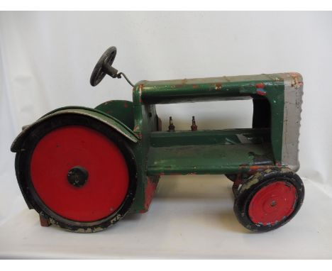 A fairground ride wooden and metal tractor, possibly a Fordson.