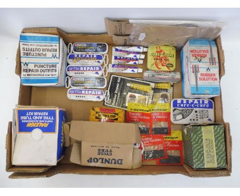 A collection of puncture repair outfits, some new old stock in dispensing boxes, also a Dunlop repair tin, a Lucas cycle lamp