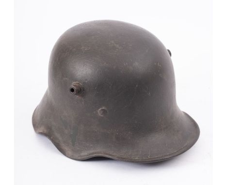 A WWI German steel helmet with Bavarian shield flash to left hand side and remains of original white leather canvas liner