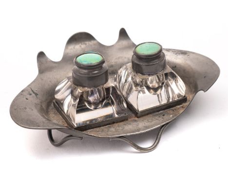 An Arts and Crafts pewter and glass two bottle inkwell by Connell, 83 Cheapside, decorated with three Ruskin style blue green