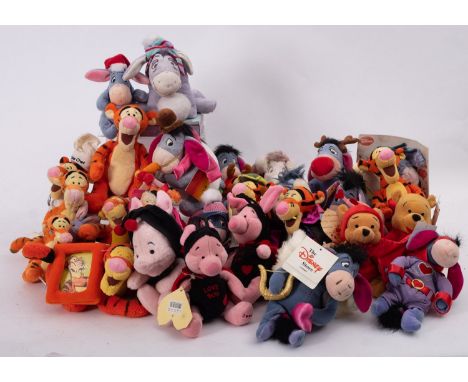 A collection of Disney 'Winnie The Pooh' soft toy figures in various costumes. 