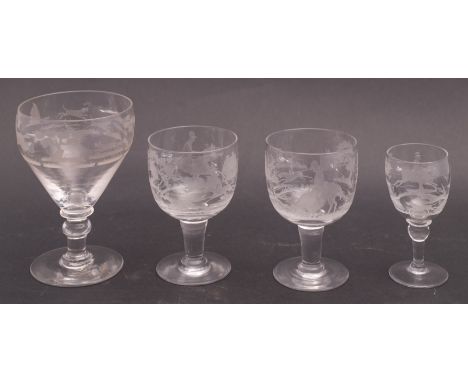 A group of four 19th century hunting theme drinking glasses, comprising a rummer, a pair of wine glasses and a port glass (4)