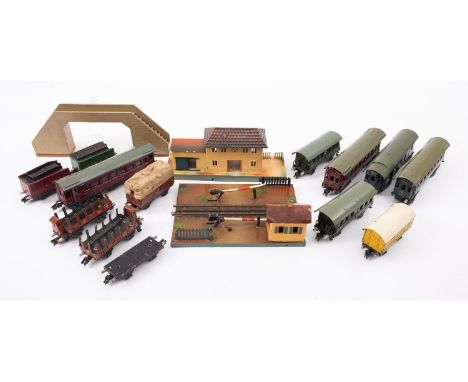 Marklin OO/HO gouge. An unboxed collection of passenger coaches and rolling stock, together with a level crossing, a station,
