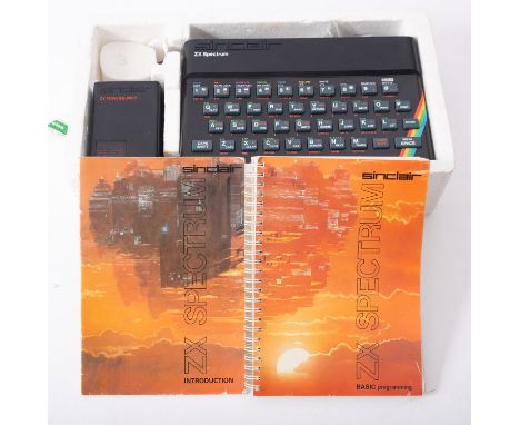 A  Sinclair ZX Spectrum 48K Personal Home Computer, in original styrofoam box with  cables and transformer , together with ma