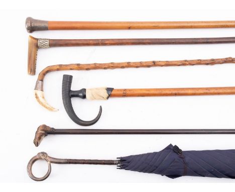 A silver topped walking cane, a silver topped lady's umbrella, a blackthorn walking cane with boar's tusk and silver mount, c