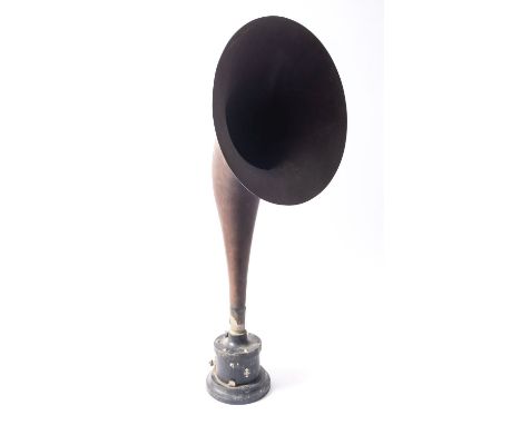 An early 20th century Western Electric style speaker with brown mache horn on a black iron base with remains of BBC transfer,