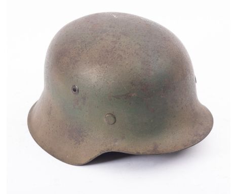 A German WWII M1944 steel helmet, the exterior with remains of insignia, and stamped NSG6 DZ39 to interior