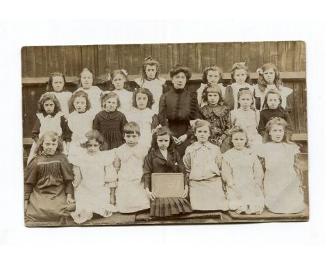 An album containing approximately 291 photographic postcards, all group portraits of school children, including some in class
