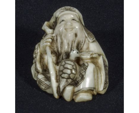 A Japanese ivory netsuke, man with staff and turtle, signed