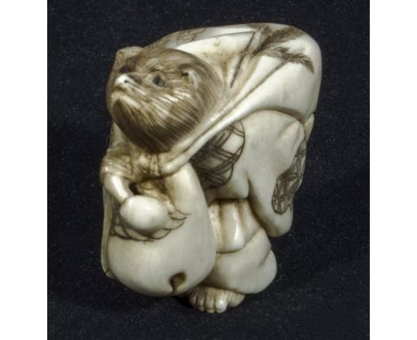 A Japanese netsuke, rat carrying a sack, signed