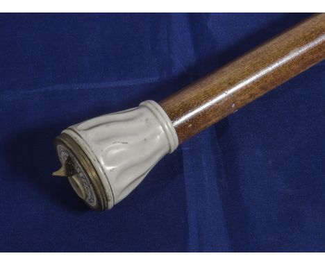A walking cane with sundial and compass top
