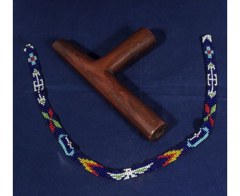 An antique Native American Indian Northern Plains catlinite pipe 20cm long together with a glass bead head band 53cm long