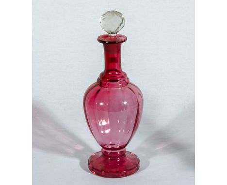 A cranberry glass decanter