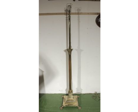 A Victorian Corinthian style heavy quality style brass telescopic standard lamp on square base and four paw feet