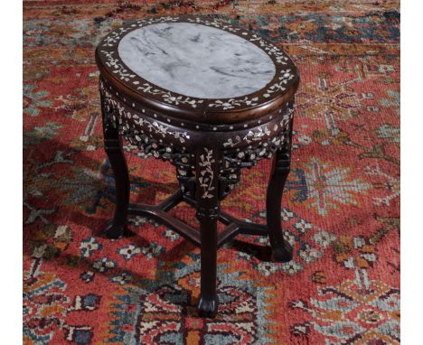 A Chinese hardwood stand with mother of pearl inlay and marble insert