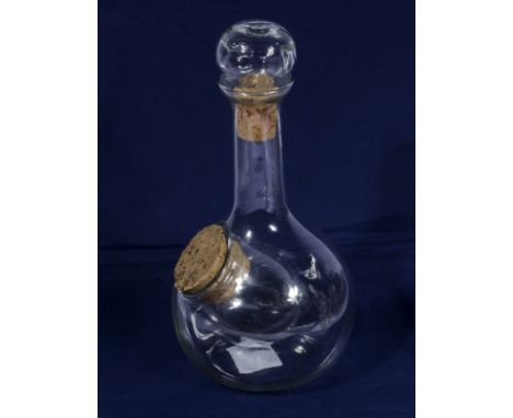 A glass decanter with side bowl