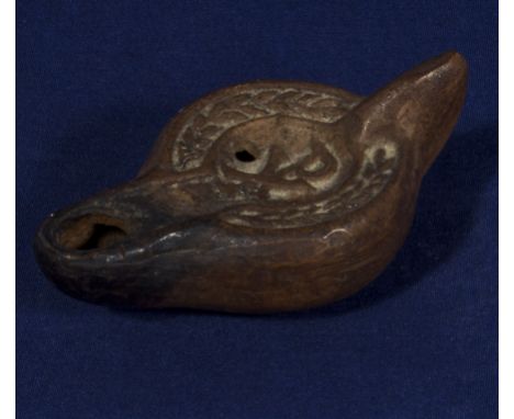 A Roman period terracotta oil lamp 'PX' decorated to the bowl, 7.5cm long and 4cm wide