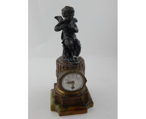 A 19th century French gilt metal column clock, surmounted with a musical amorini above an Arabic floral painted enamel dial, 