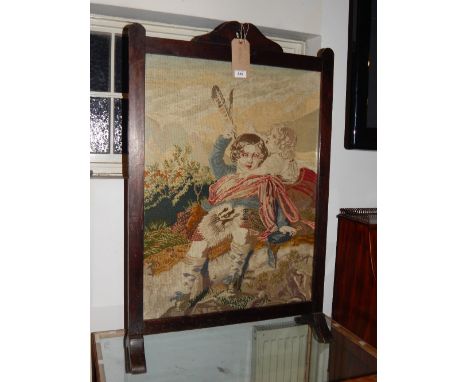 A 1920's oak and pine fire screen, inset wool work tapestry woven panel, depicting children at play. H.104cm W.69cm 40