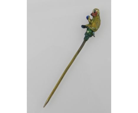 An unusual painted base metal tie pin, fashioned as a seated monkey.