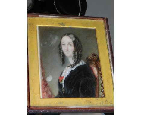 A mid 19th century British School, a half length seated portrait on ivory panel, study of a lady in mourning dress. 