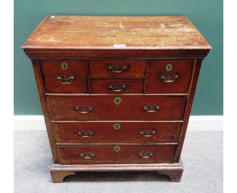 An early 18th century oak chest of four short and three long drawers, on bracket feet, 81cm wide x 92cm high x 46cm deep.