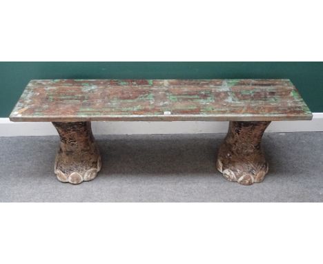 A 20th century bench, the rectangular hardwood top on a pair of faux carved elephant feet, 150cm wide x 46cm high x 37cm deep