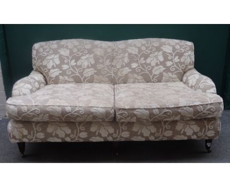 Wesley Barrell; a 20th century twin tone floral upholstered double hump back sofa, on tapering square supports, 185cm wide x 