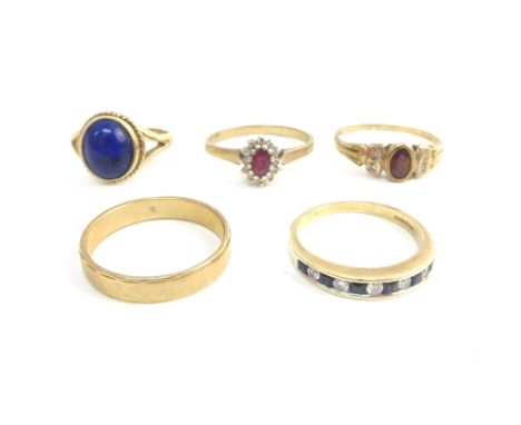 A 9ct gold ring, mounted with an oval lapis lazuli, a 9ct gold, sapphire and diamond eleven stone half eternity ring, two fur