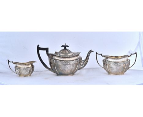 A silver three piece tea set, comprising; a teapot, a twin handled sugar bowl and a milk jug, each piece of shaped oval form,