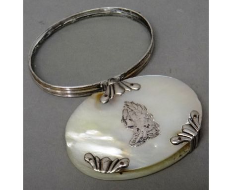 A silver and mother-of-pearl oval folding magnifying glass, the centre of the front decorated with the portrait of George II,