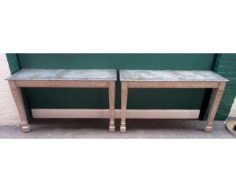 A pair of console tables, each with rectangular faux marble top on a pair of grey painted tapering square supports, with carv