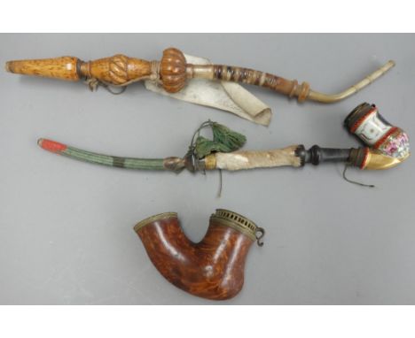 An Austrian porcelain pipe bowl, an Austrian burr maple carved pipe, and one further 19th century Continental wooden pipe bow