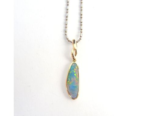 A gold and opal doublet set pendant, in a drop shaped design, detailed 14 K 585, with a base metal neckchain.