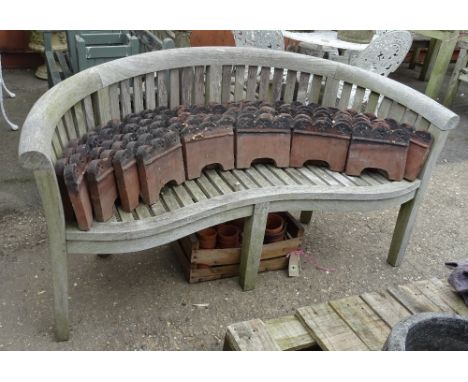 A 20th century hardwood curved back garden bench, stamped Swan, 170cm wide x 85cm high. 