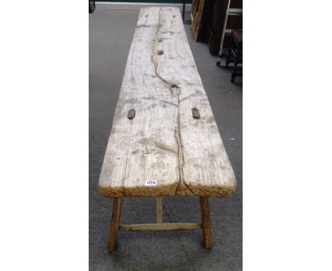 A rustic console table, the single slab rectangular driftwood top on four staked supports, 267cm wide x 77cm high x 39cm deep