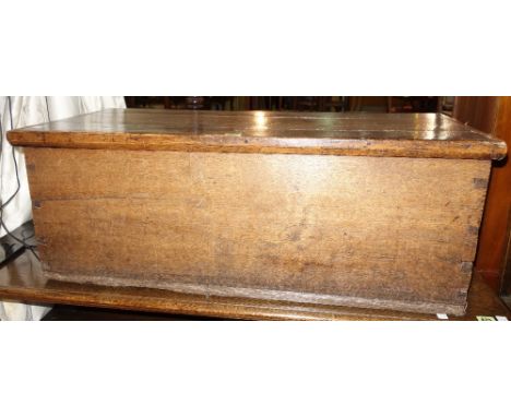 A 19th century oak rectangular lift top trunk, 93cm wide x 34cm high.