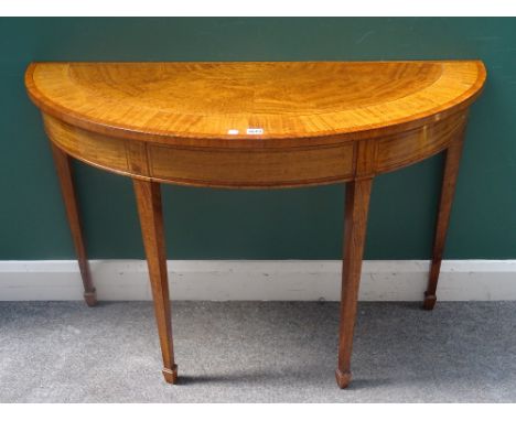 A George III style satinwood semi-elliptic console table, on tapering square supports, 113cm wide x 76cm high x 45cm deep.