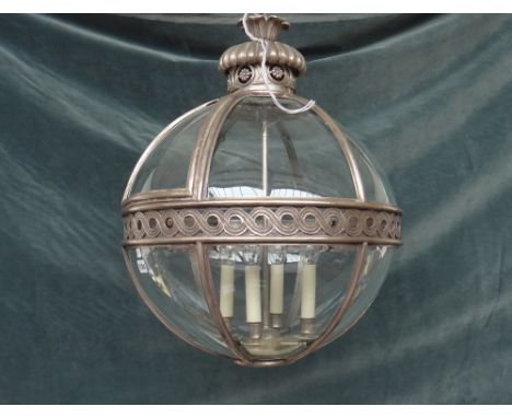 A modern silvered metal lantern, of globular sectional form, with a foliate pierced crown and internal four light fitment, 58