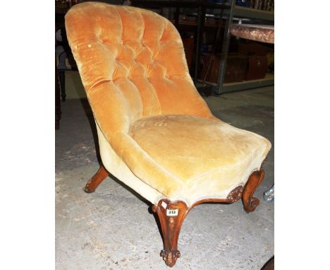A Victorian walnut framed button back upholstered nursing chair on carved cabriole supports. 
