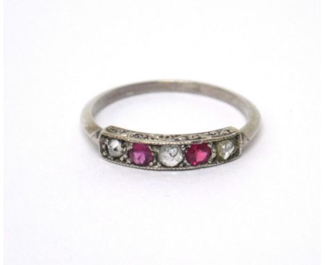 A ruby and diamond five stone ring, mounted with two cushion shaped rubies, alternating with three variously cut diamonds, ri