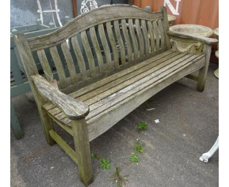 A 20th century hardwood hump-back garden bench, 160cm wide x 85cm high.  