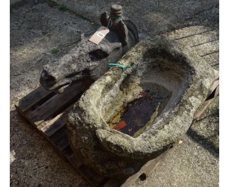 A composition stone classical horse's head, 66cm wide x 43cm high, and a roughly hewn granite trough, 75cm wide x 32cm high, 