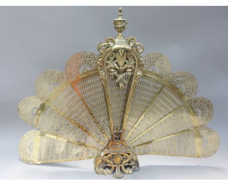 A Victorian style brass folding fire screen of pierced foliate form, 71.5cm high. 