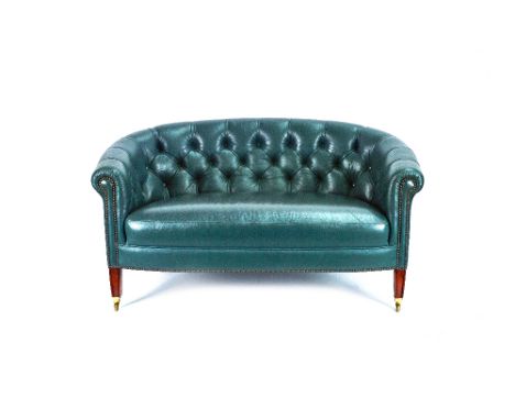 A small George III style green leather upholstered tub back sofa, on tapering square mahogany supports, 133cm wide x 69cm hig