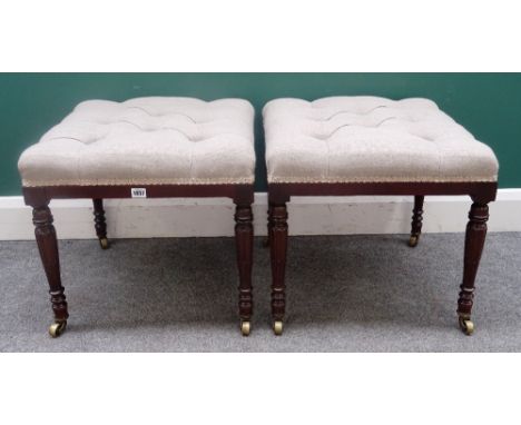 A pair of square footstools, each with button upholstered over-stuffed seats, on 19th century fluted mahogany supports, 50cm 